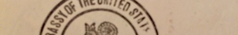 Part of the official seal. Letters at least partially visible say "assy of the United States"